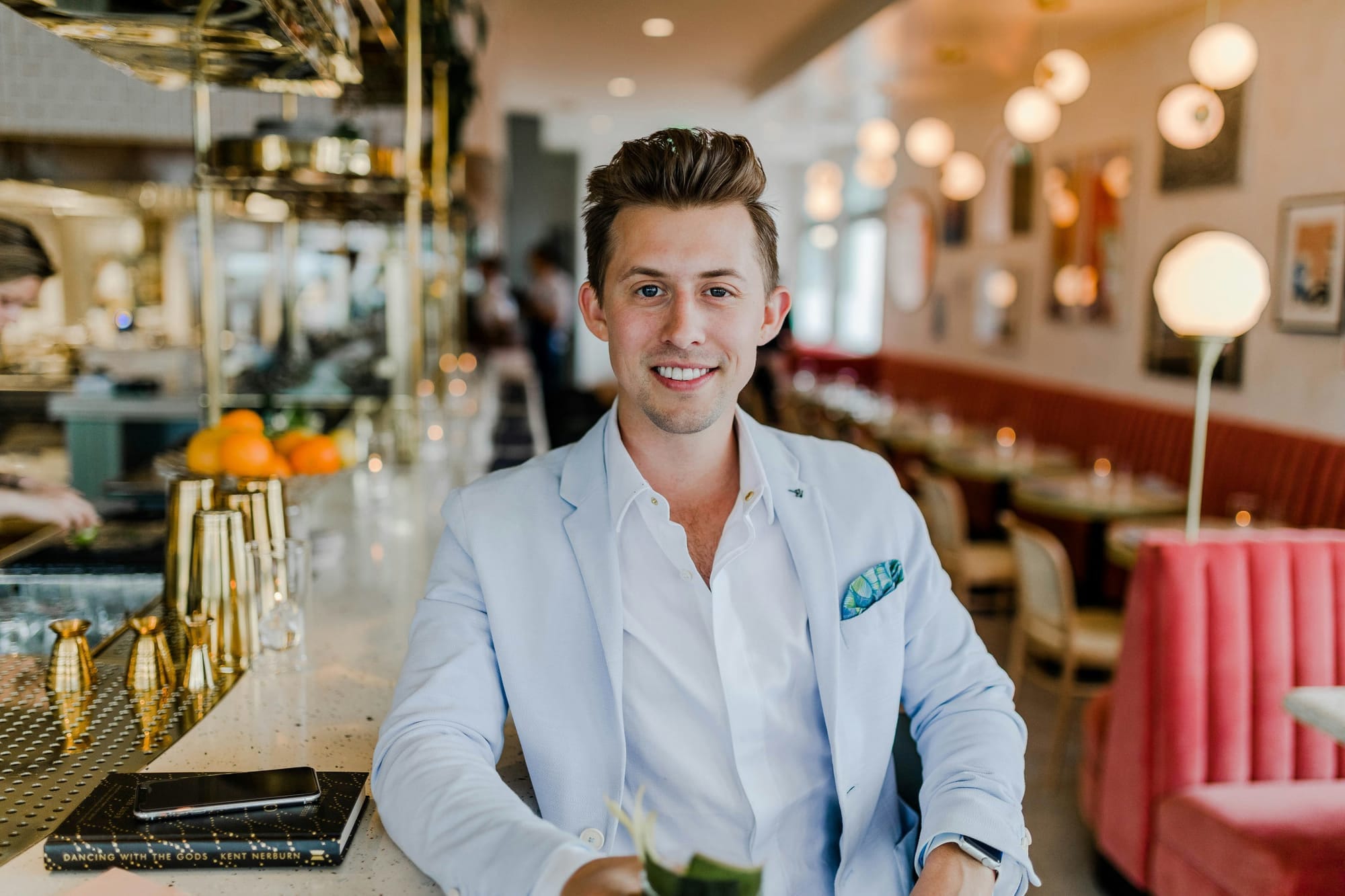 A man in a grey suit giving a big smile for a professional headshot