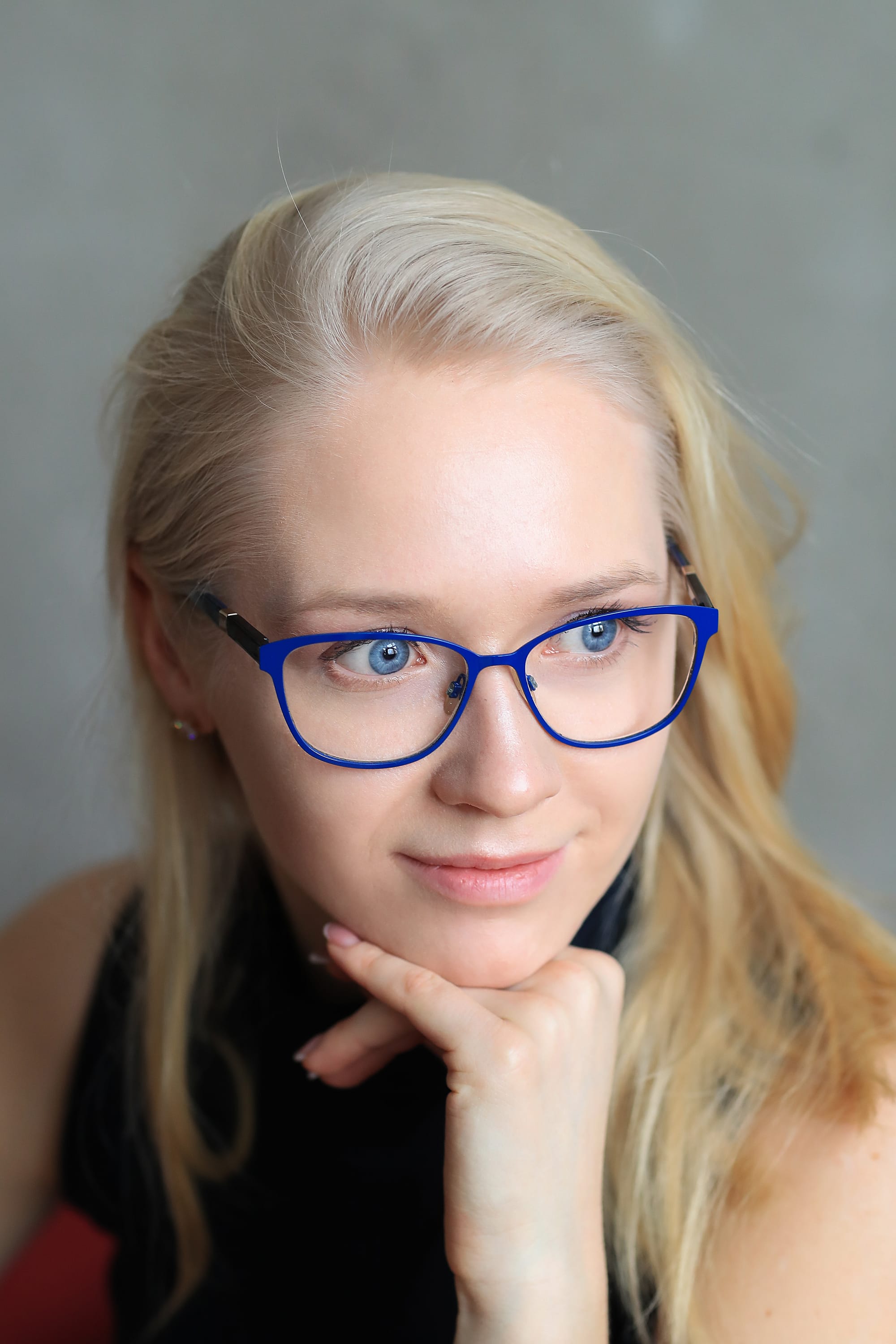 A lady posing for a headshot with her glasses on